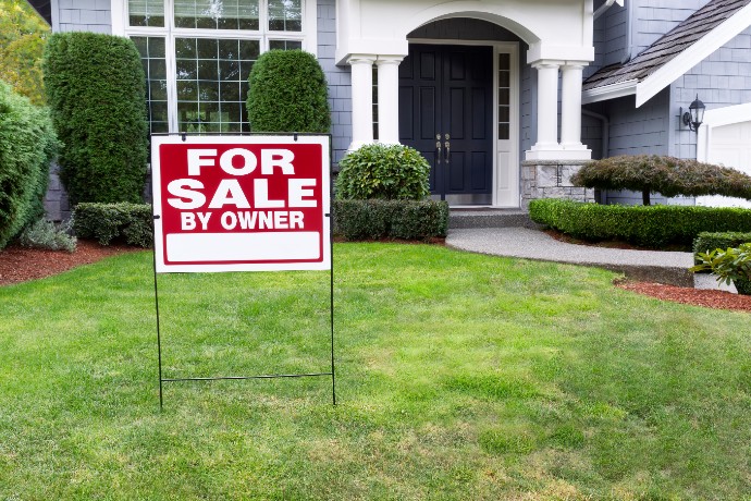 Closeup view of Modern Suburban Home for Sale Real Estate Sign in front of modern home